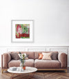Green and red art in a white livingroom